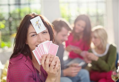 simsearch:6109-06007153,k - Smiling woman playing card game Foto de stock - Sin royalties Premium, Código: 6113-06625611