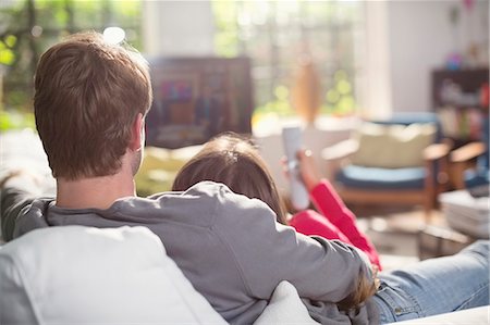 Couple relaxing on sofa together Stock Photo - Premium Royalty-Free, Code: 6113-06625633