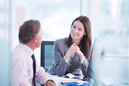 simsearch:6113-06625746,k - Business people talking at desk Stock Photo - Premium Royalty-Free, Code: 6113-06625744