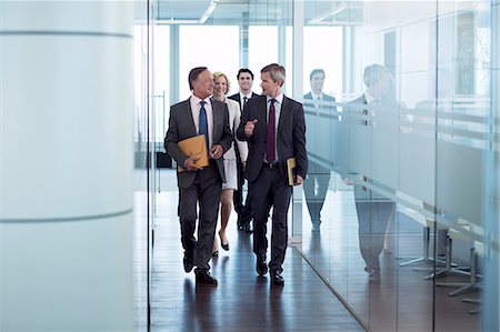 front view - Businesspeople walking in hallway Stock Photo - Premium Royalty-Free, Code: 6113-06625764