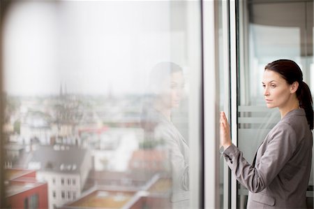 reflection and window - Businesswoman standing at office window Stock Photo - Premium Royalty-Free, Code: 6113-06625765