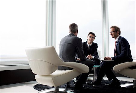 simsearch:6113-06625813,k - Businessmen talking in office lobby Stock Photo - Premium Royalty-Free, Code: 6113-06625778