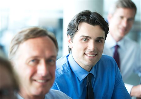 simsearch:6113-06625746,k - Businessmen smiling in meeting Stock Photo - Premium Royalty-Free, Code: 6113-06625789