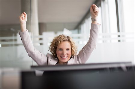 simsearch:6113-06625697,k - Businesswoman cheering in office Stock Photo - Premium Royalty-Free, Code: 6113-06625710