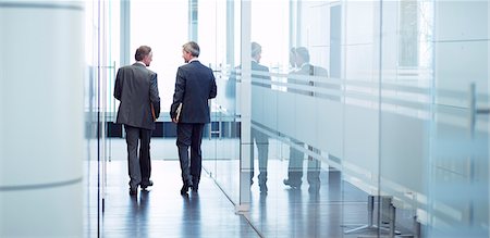 simsearch:6113-06753511,k - Businessmen talking in office hallway Stock Photo - Premium Royalty-Free, Code: 6113-06625728