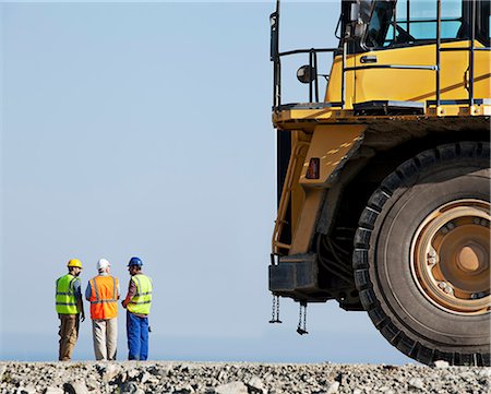 scale (contrast in size) - Workers talking with machinery in quarry Stock Photo - Premium Royalty-Free, Code: 6113-06625849