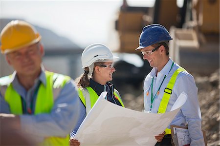 Business people reading blueprints in quarry Stock Photo - Premium Royalty-Free, Code: 6113-06625862