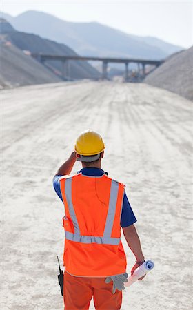 soil hill - Worker standing on road in quarry Stock Photo - Premium Royalty-Free, Code: 6113-06625879