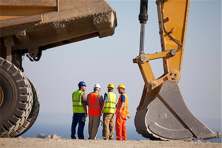 excavations - Workers talking by machinery in quarry Stock Photo - Premium Royalty-Free, Code: 6113-06625952