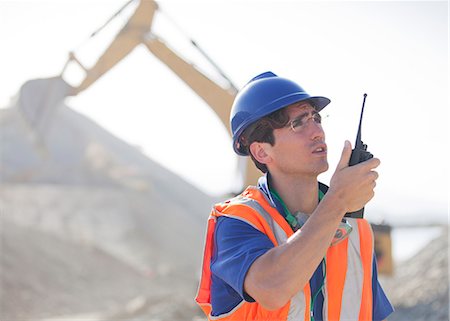 simsearch:6113-06625850,k - Worker using walkie-talkie in quarry Photographie de stock - Premium Libres de Droits, Code: 6113-06625965