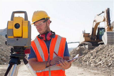 simsearch:6113-06625972,k - Worker using leveling equipment in quarry Foto de stock - Sin royalties Premium, Código: 6113-06625985