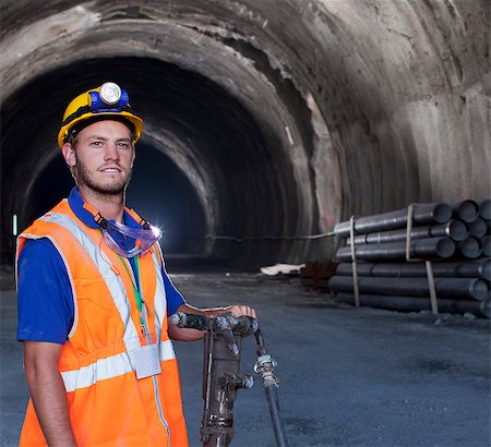 flashlight holding - Worker standing in tunnel Stock Photo - Premium Royalty-Free, Code: 6113-06625902