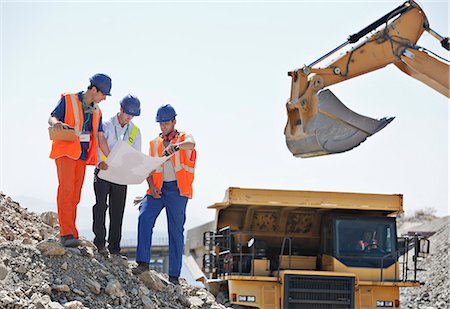 protector de oídos - Workers and businessman reading blueprints in quarry Foto de stock - Sin royalties Premium, Código: 6113-06625915