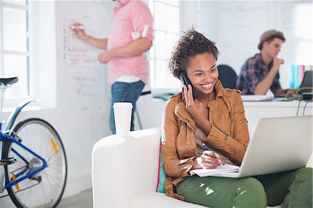 start up - Businesswoman taking notes on phone in office Stock Photo - Premium Royalty-Free, Code: 6113-06626040