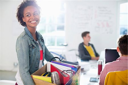 small business beginning - Businesswoman carrying cardboard box of belongings Stock Photo - Premium Royalty-Free, Code: 6113-06626052