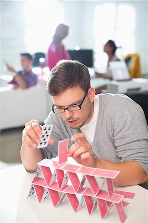 prudenza - Businessman making house of cards in office Fotografie stock - Premium Royalty-Free, Codice: 6113-06626075