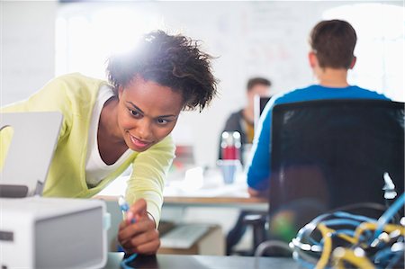 startup man woman from back - Businesswoman using printer at desk Stock Photo - Premium Royalty-Free, Code: 6113-06626008