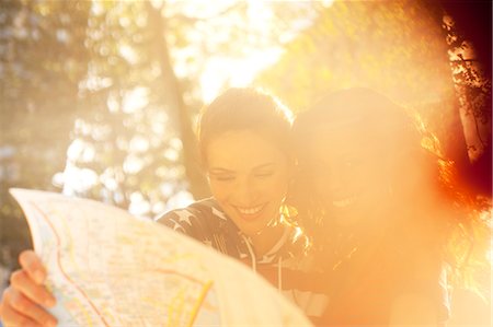 Women looking at roadmap outdoors Stock Photo - Premium Royalty-Free, Code: 6113-06626143