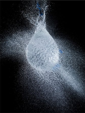 spraying water - High speed image of water balloon popping Stock Photo - Premium Royalty-Free, Code: 6113-06626100