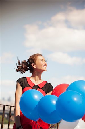simsearch:632-06118588,k - Woman carrying bunch of balloons Stock Photo - Premium Royalty-Free, Code: 6113-06626134