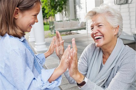 simsearch:6113-06626338,k - Woman and granddaughter playing clapping game Stock Photo - Premium Royalty-Free, Code: 6113-06626295