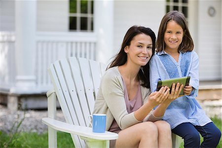 Mother and daughter using digital tablet outdoors Stock Photo - Premium Royalty-Free, Code: 6113-06626353