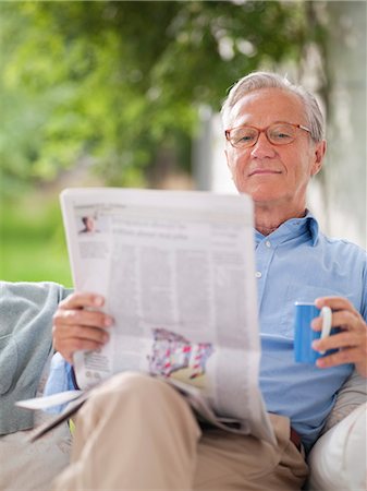 porch coffee - Man reading newspaper in porch swing Stock Photo - Premium Royalty-Free, Code: 6113-06626352