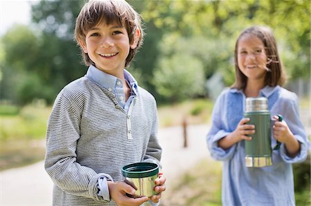 Children drinking from thermos outdoors Stock Photo - Premium Royalty-Free, Code: 6113-06626372