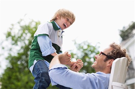 portrait and funny glasses - Father and son playing outdoors Stock Photo - Premium Royalty-Free, Code: 6113-06626395