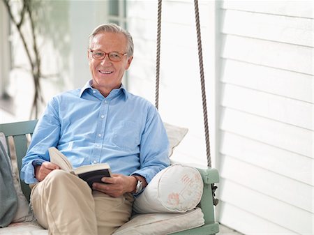 pictures of older adults sitting on porch swing - Man reading book on porch swing Stock Photo - Premium Royalty-Free, Code: 6113-06626312
