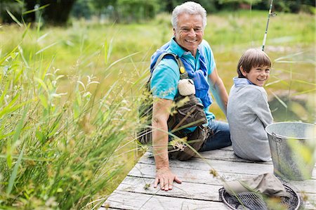 seniors with grandkids - Man fishing with grandson on wooden dock Stock Photo - Premium Royalty-Free, Code: 6113-06626316