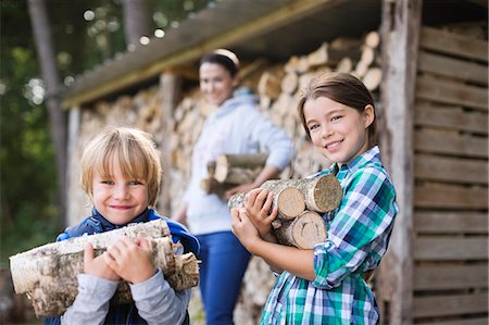 Children carrying firewood outdoors Stock Photo - Premium Royalty-Free, Code: 6113-06626319