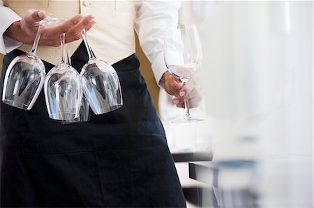 Waiter carrying wine glasses in restaurant Photographie de stock - Premium Libres de Droits, Code: 6113-06626561