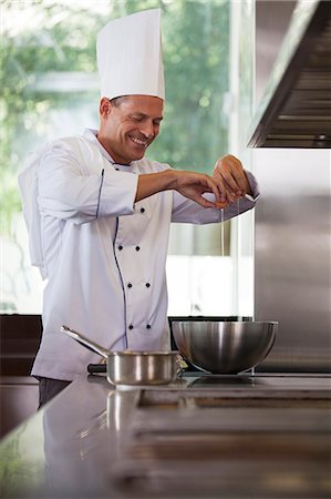 eggs in bowl - Waiter cooking in restaurant kitchen Stock Photo - Premium Royalty-Free, Code: 6113-06626569