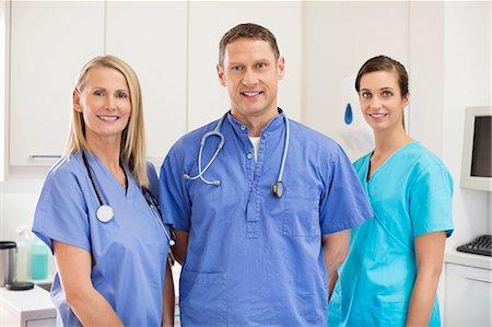 scrubs - Smiling veterinarians standing together in vet's surgery Stock Photo - Premium Royalty-Free, Code: 6113-06626522