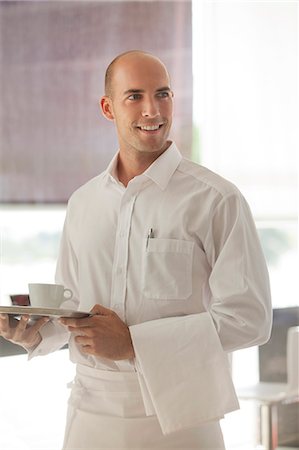 Waiter carrying cup of coffee in restaurant Photographie de stock - Premium Libres de Droits, Code: 6113-06626539