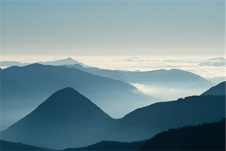 simsearch:6113-06625554,k - Aerial view of mountaintops over clouds Stock Photo - Premium Royalty-Free, Code: 6113-06626720