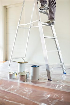 person climbing the ladder - Man climbing ladder to paint room Stock Photo - Premium Royalty-Free, Code: 6113-06753240