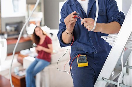 remodel customer - Electrician working in living room Stock Photo - Premium Royalty-Free, Code: 6113-06753246