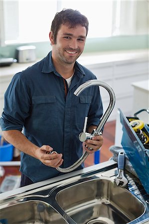 simsearch:6113-06753289,k - Plumber working on kitchen sink Stock Photo - Premium Royalty-Free, Code: 6113-06753259