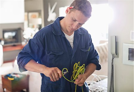 serious man not business - Electrician cutting wires in home Stock Photo - Premium Royalty-Free, Code: 6113-06753289