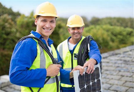 solar - Workers smiling on roof Stock Photo - Premium Royalty-Free, Code: 6113-06753209