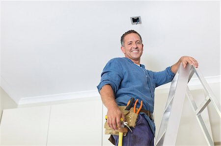 electricidad - Man working on ceiling lights Foto de stock - Sin royalties Premium, Código: 6113-06753212