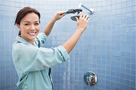 renovation - Female plumber working on shower head in bathroom Stock Photo - Premium Royalty-Free, Code: 6113-06753214