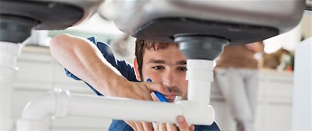 pipe - Plumber working on pipes under sink Stock Photo - Premium Royalty-Free, Code: 6113-06753222