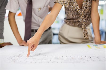 relationship problem - Business people reading blueprints in meeting Stock Photo - Premium Royalty-Free, Code: 6113-06753446