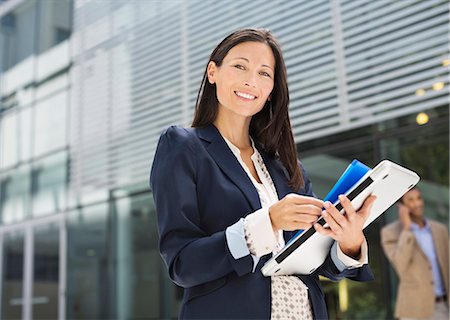 Businesswoman walking on city street Stock Photo - Premium Royalty-Free, Code: 6113-06753492