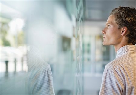 reflection and window - Businessman looking out office window Stock Photo - Premium Royalty-Free, Code: 6113-06753494