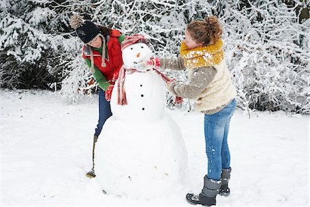 playing outdoor snow - Mother and daughter making snowman Stock Photo - Premium Royalty-Free, Code: 6113-06753409