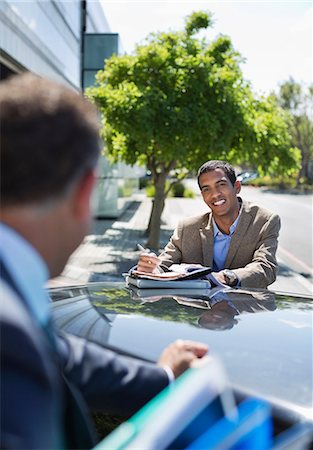 people standing on standing on roof of car - Businessmen talking at car Stock Photo - Premium Royalty-Free, Code: 6113-06753430